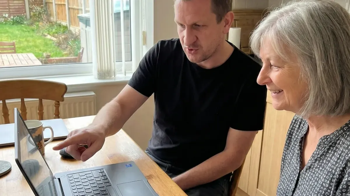 Martyn helping a client with their laptop