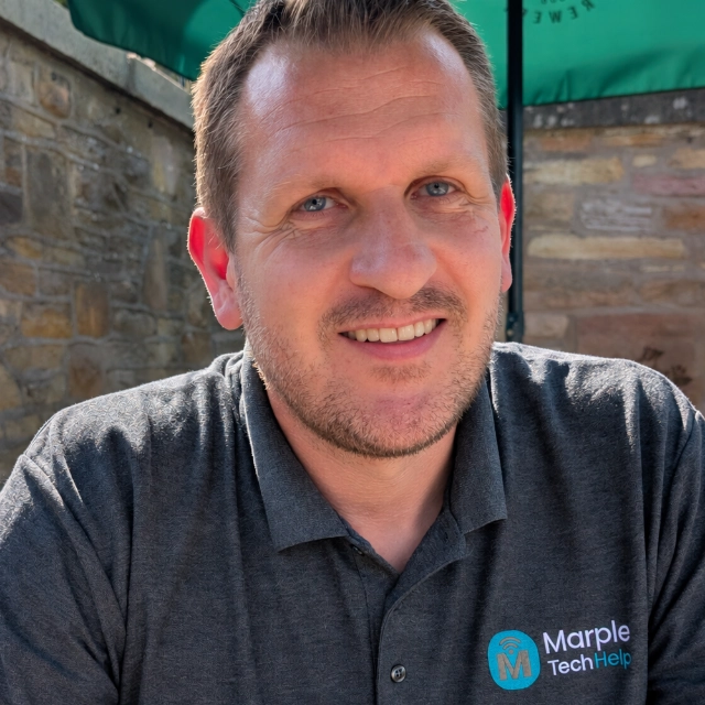 Martyn, who runs Marple Tech Help, smiling and wearing a Marple Tech Help polo shirt